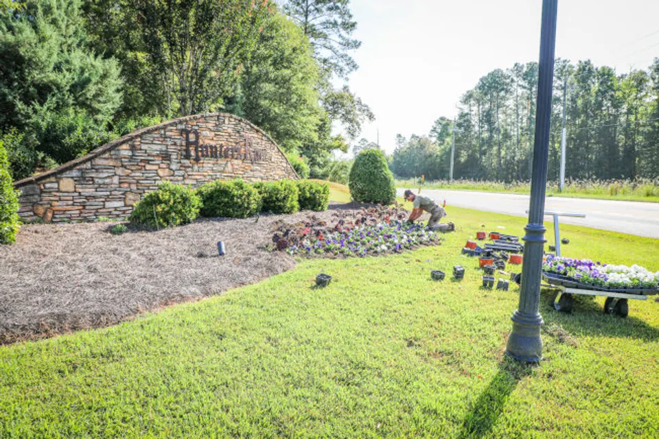 Flower installation in a fresh landscape bed by Sparta Lawn Care